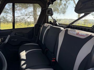 Interior view of a vehicle's backseat with black and gray upholstery.