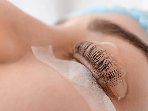 Woman getting eyelashes treatment