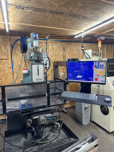 Industrial CNC milling machine with computer control in a workshop.