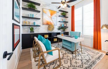 Modern home office with vibrant orange curtains and turquoise accents.