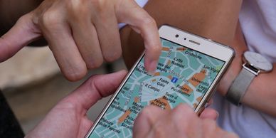 Fingers pointing at a map on a smart phone