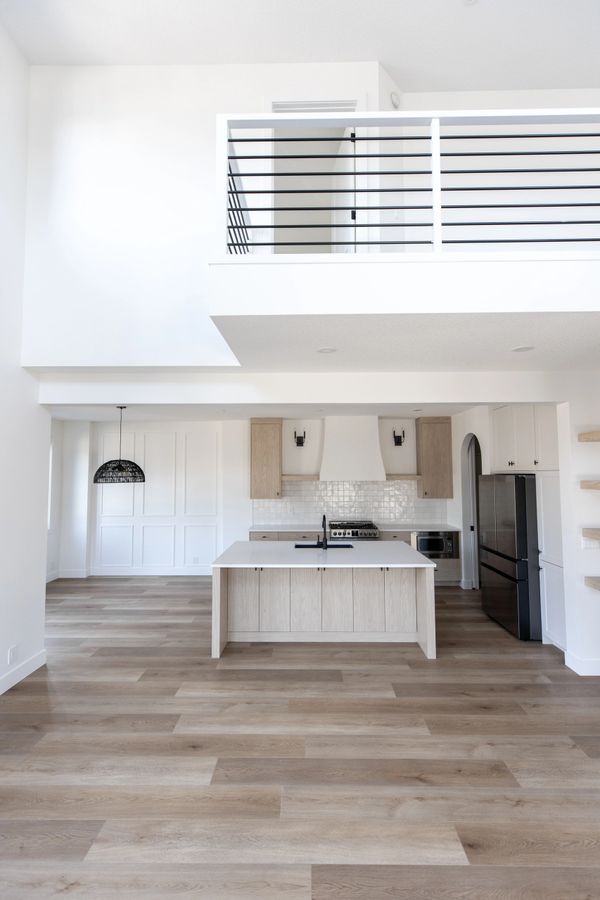 kitchen with view of upstairs stairs railing