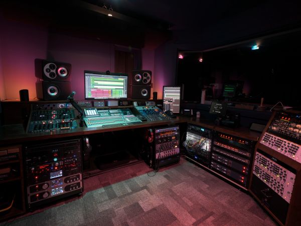 Professional audio mixing studio with various sound equipment.