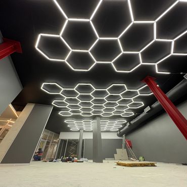 Modern interior with hexagonal LED ceiling lights and industrial design elements.