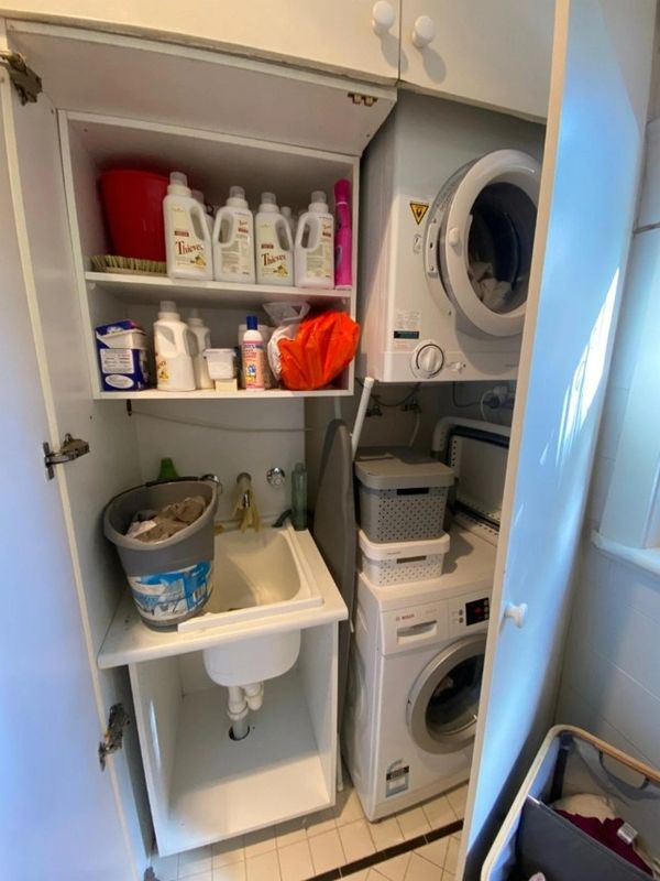 Cluttered and messy laundry before organisation and cabinetry design
