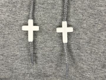 White cross charms on sweatshirt drawstrings