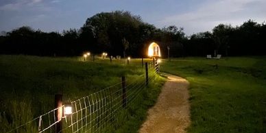 Evening view of the approach to Rutland Rural Retreats glamping pods from the bridge
