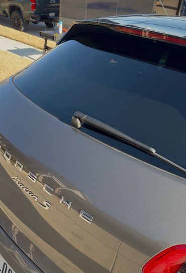 Close-up of a Porsche Macan S rear with tinted window and wiper.