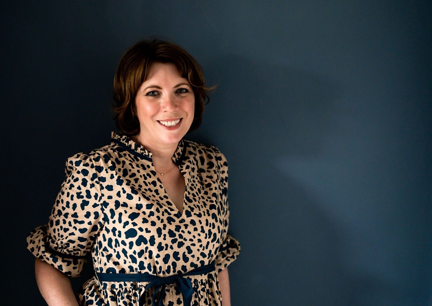 Jane Griffin, Founder and Director, Positive Story PR Consultancy wearing a leopard print dress.
