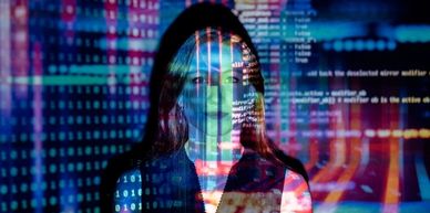Picture of woman with tech coding reflected on her face