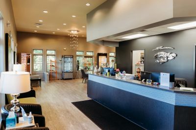 Modern eye care clinic reception with stylish decor and eyewear displays.