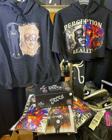Clothing display with artistic hoodies and shoes.