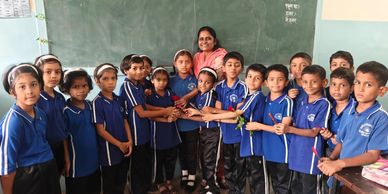 Group of students with their teacher in a classroom.