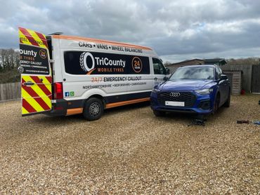 Mobile tyre service van fitting a brand new premium tyre on this customers Audi
