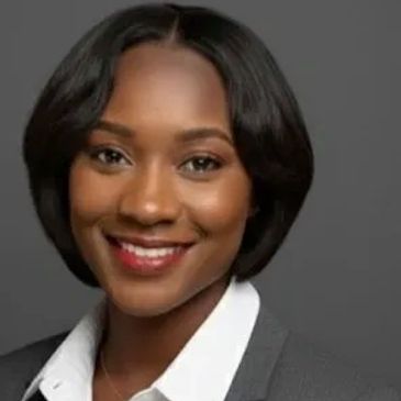 Professional woman smiling confidently in business attire.
