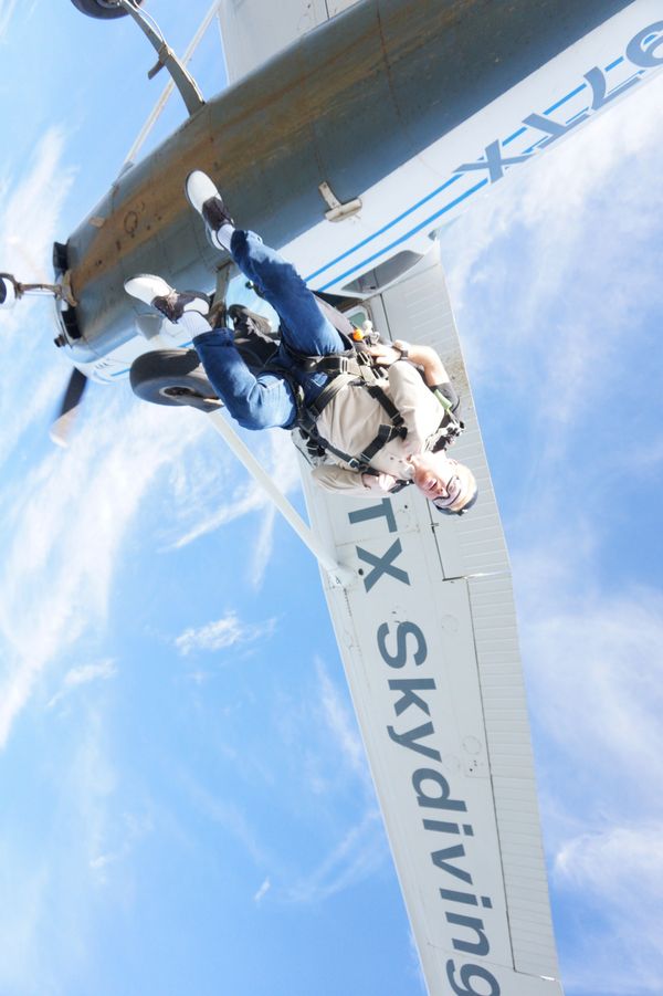 Person exiting a plane for a skydive.