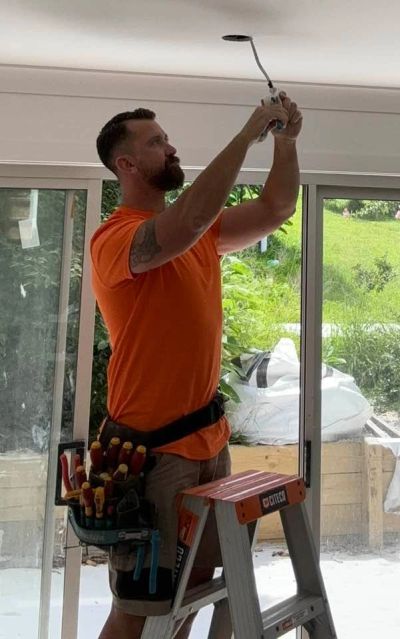 NextPhase Electrical Solutions tradesman installing LED downlights in Newcastle 2300