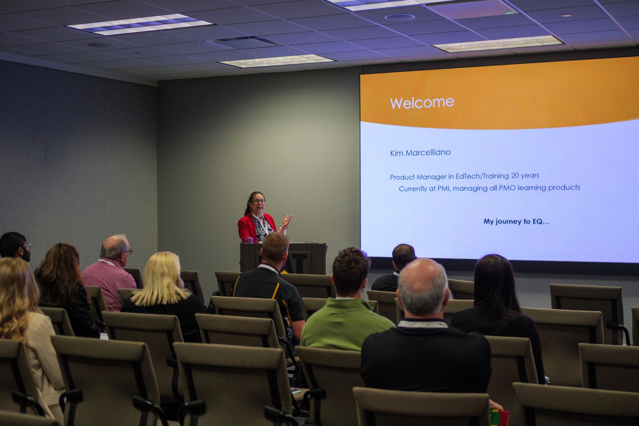 A woman presents to an audience about her journey to emotional intelligence.