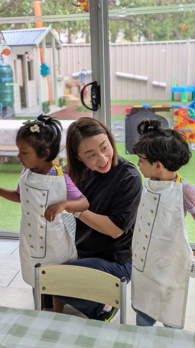 Seven Stars founder engaging with children during an early learning experience at Seven Stars Early Centre.
