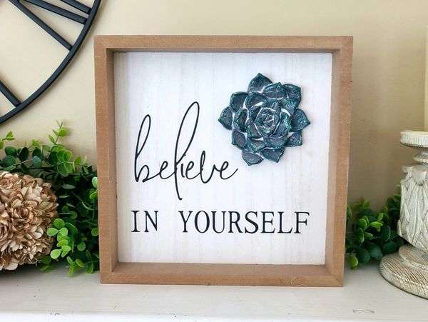 Decorative sign saying 'believe in yourself'.
