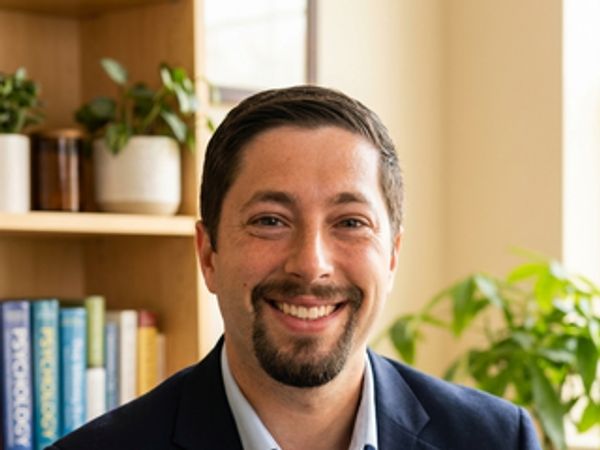 Smiling man in business attire indoors.