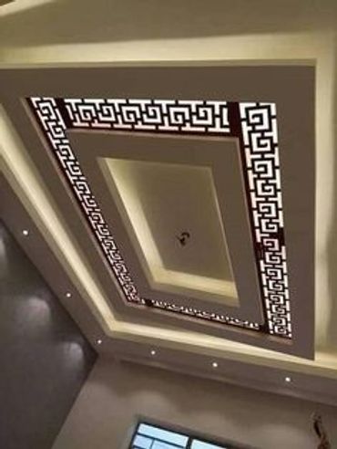 Modern ceiling design with geometric patterns and embedded lighting.