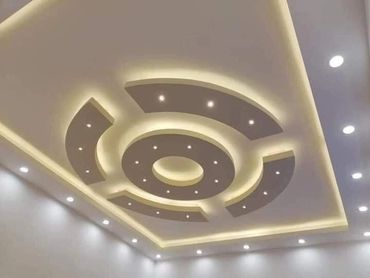 Modern ceiling design with circular recessed lighting and warm ambient glow.