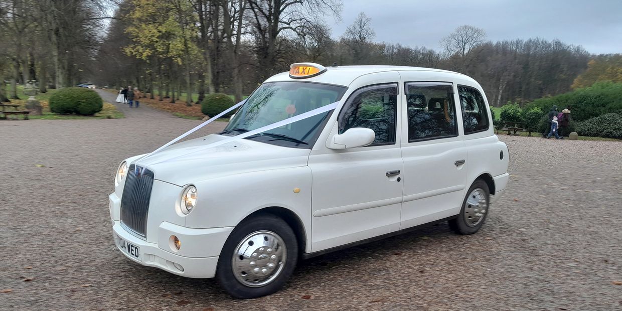 A delightful white wedding taxi with a grey velour interior. Wedding car hire, Wedding taxi hire