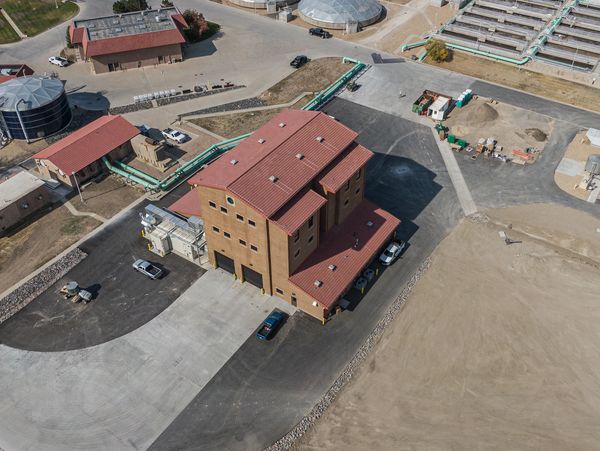 Overview of the City's wastewater treatment plant showing a three-story building at center.
