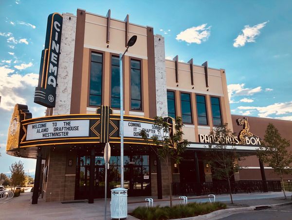 View of the Alamo Drafthouse theater corner with canopy and marquis at the corner.