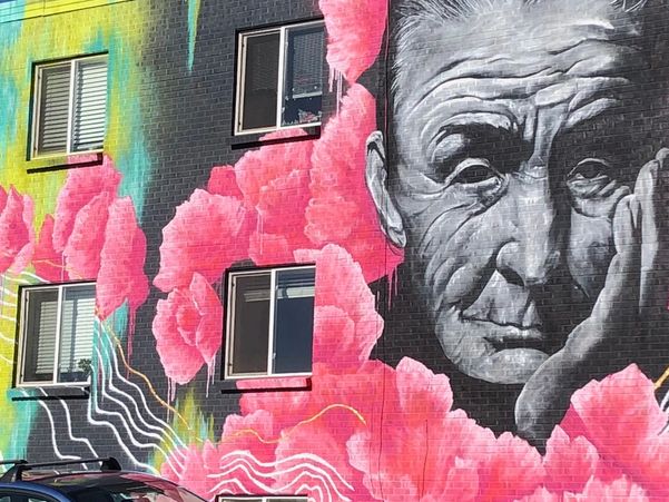 Close-up of mural on side of building in Westminster Station area that depicts an older woman