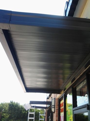 Flat pan store front awning with top framing struts