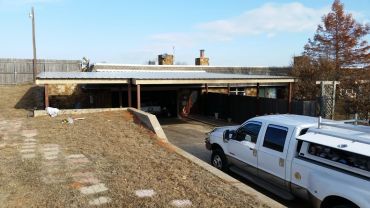 40ft x 25ft Red Steel C-Beam carport structure built at a underground house in El-Reno, OK