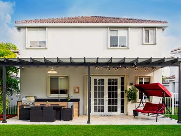 Aluminum framed patio cover with ploycarbonate roof panels that allows all of the sun to come in.