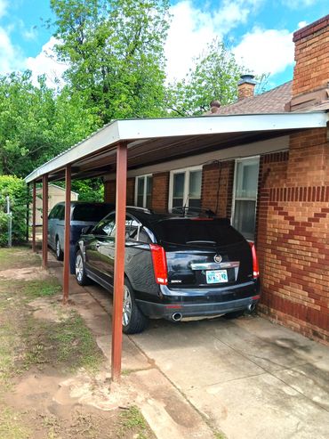 40ft x 14 ft lean too red steel frame carport with 26 ga sheet metal and bent formed trim,