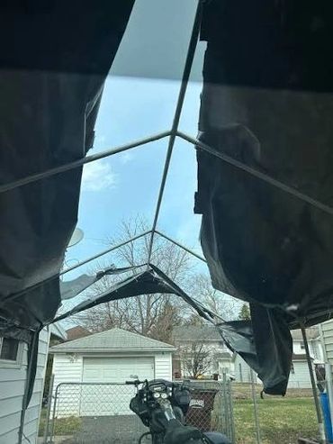 Wind damaged lightweight carport.