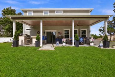 Backyard patio with seating and grill area.
