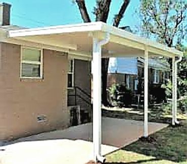 Lean-too attached rolled formed flat-pan aluminum carport with its built-in guttering system.OKC, OK