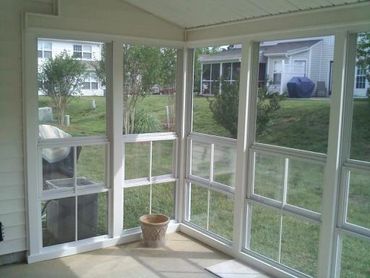 Screen room walls with fill view Eze-Breeze windows installed in white in color.