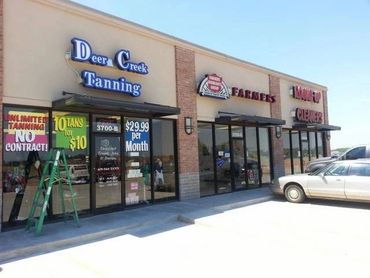 Sidewalk / Store front attached flat pan awnings built in Deer Creek. Bronze in color.