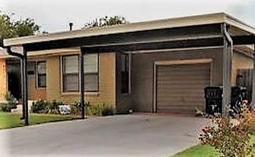 20ft x 20ft attached W-Pan steel carport in wheat color canopy with bronze poles beams downspouts.  