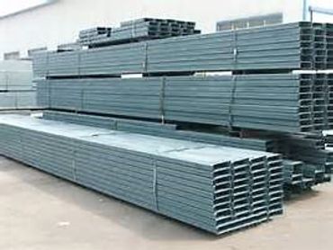 Stacks of metal sheets neatly piled outdoors.