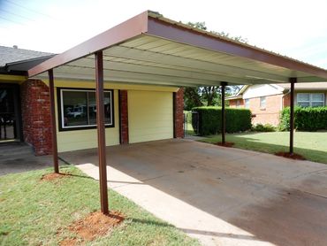 Attached 20ftx20ft Galvanized steel framed carport with upgraded factory painted poles in brown