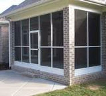 Screen room walls with door built between brick columns.