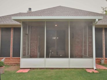Attached 3-inch SIP patio cover with screened in walls and door for a screen room all in white color