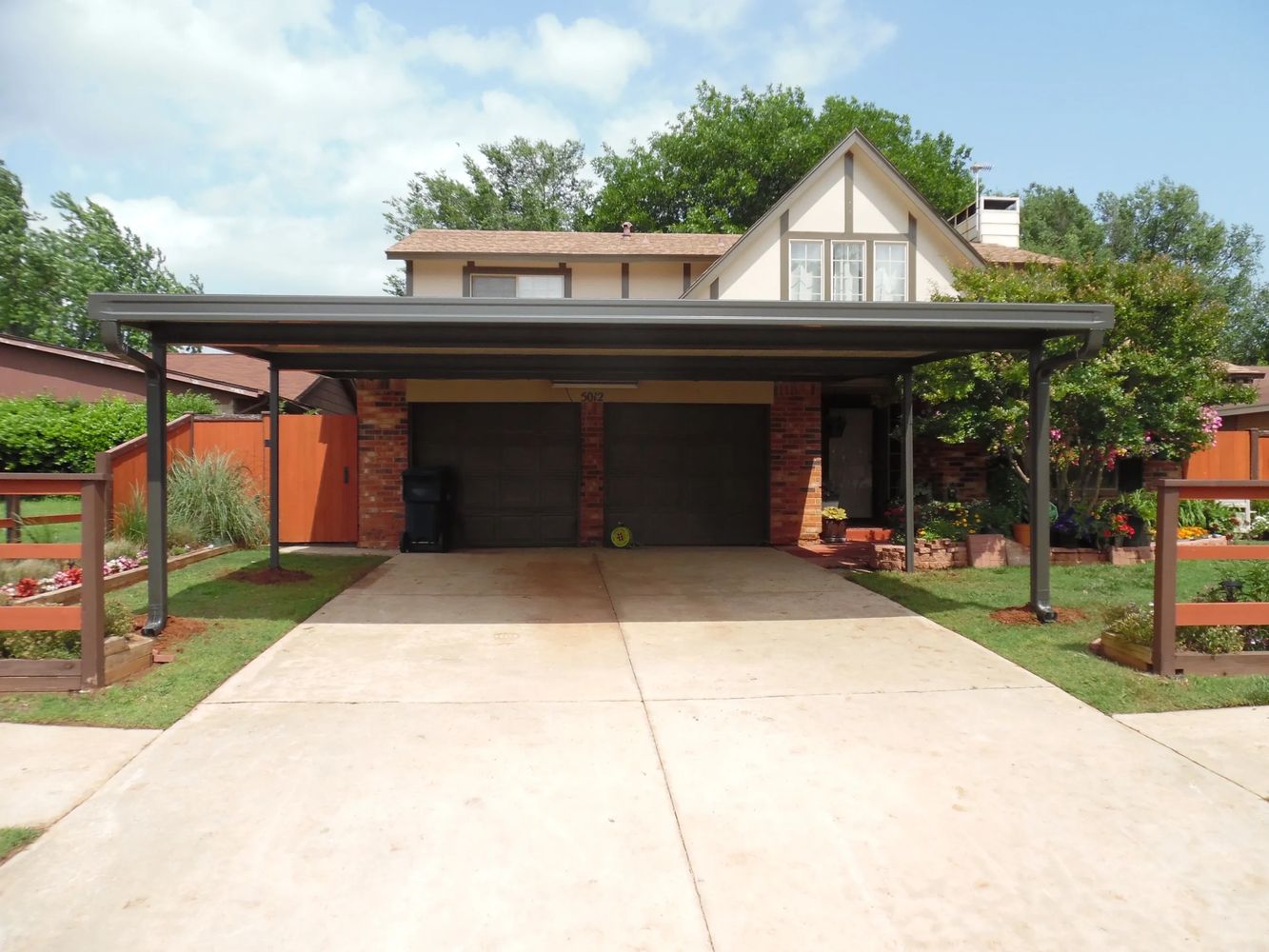24ft x 24ft Oversized 2-1/2 car attached Flat-pan aluminum carport with built-in guttering bronze.