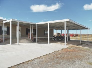 Large 40ftx24ft Galvanized steel framed 4-car carport with 15ft patio cover attached.