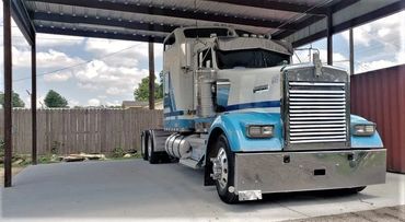 Larger C-beam red steel non-painted carport frame with side skirts. 26ga rolled formed sheet metal