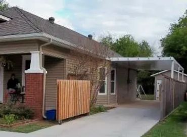 16ft X 35ft attached structural Insulated panel carport with Santa-Fe trim and rafter tail ends.