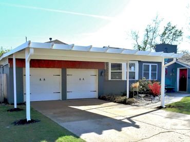 20ft X 20ft attached rolled formed steel flat pan carport with the Santa-Fe package trim added